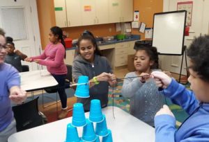 Girls work on a STEM experiment at Girls Inc of Lynn